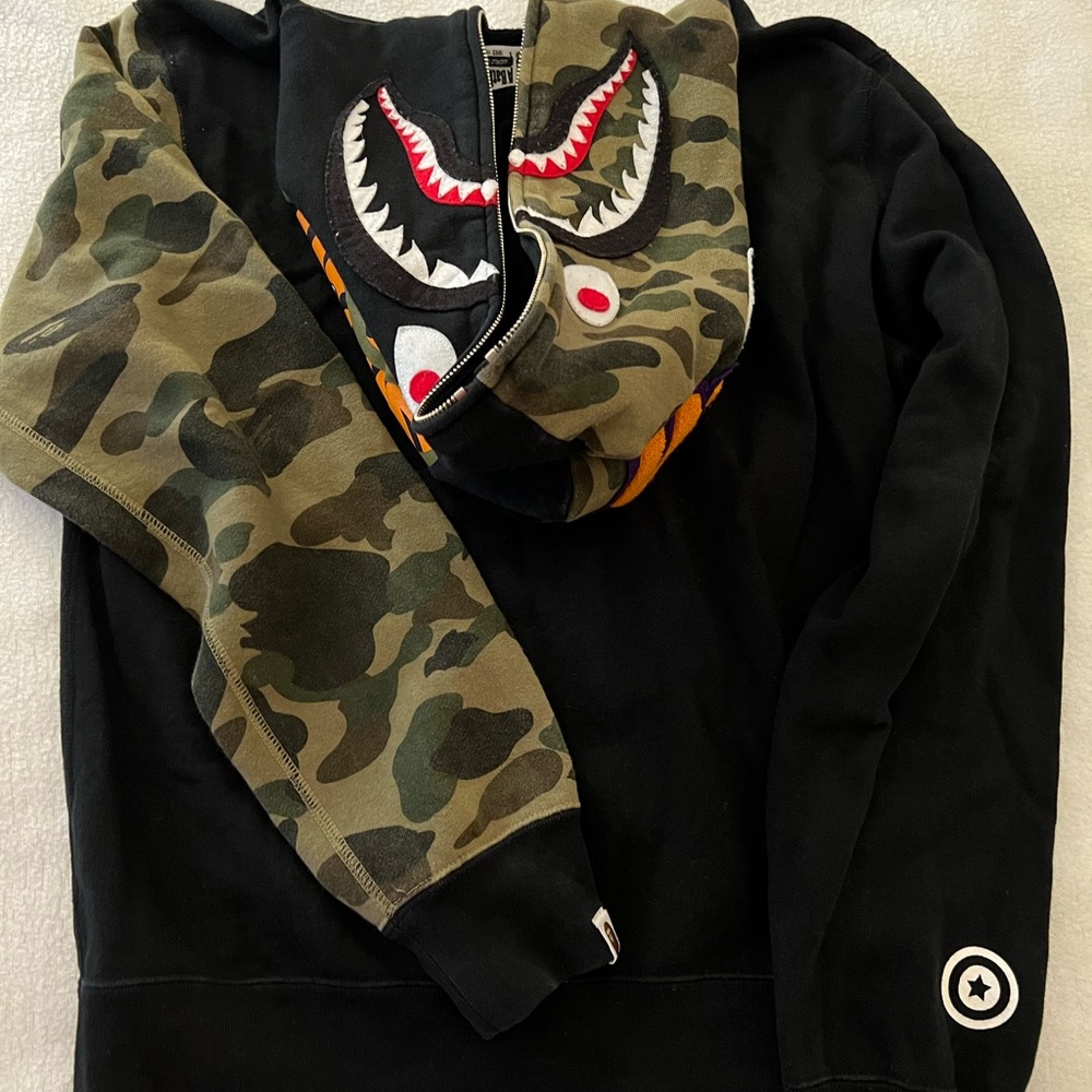 A Bathing Ape- World gone mad 1993-2093. Black sweatshirt with design.